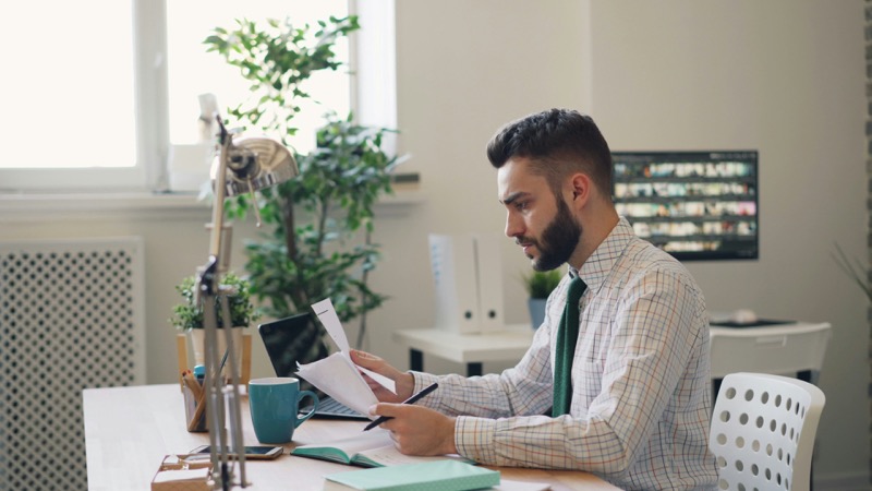 Professional reviewing plan documents at a desk